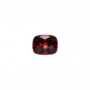 May include: A deep red cushion-cut gemstone with a faceted surface.