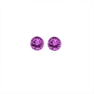 May include: A pair of small, round, purple stud earrings.