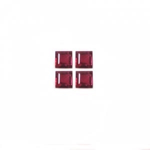 May include: Four square-shaped, red gemstones. The gemstones are faceted and have a shiny finish.