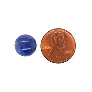 May include: A round, blue gemstone cabochon, approximately the size of a US penny.