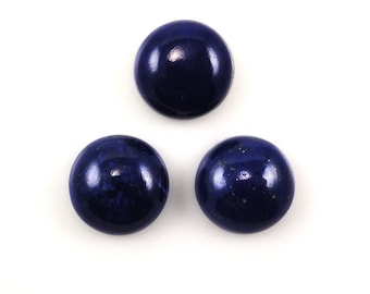 May include: Three round, dark blue lapis lazuli cabochons with gold flecks.