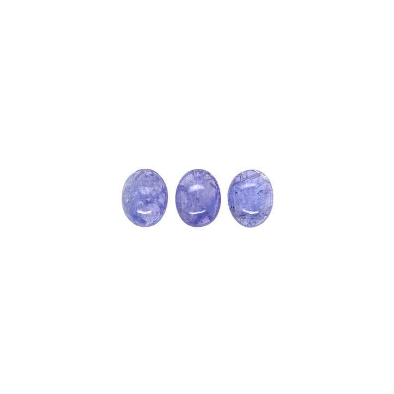 May include: Three oval-shaped, translucent blue gemstones with a light purple hue.
