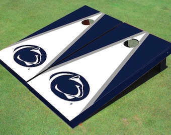 May include: A set of two blue and white cornhole boards with a gray stripe and a white Nittany Lion logo on each board.