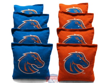 May include: Set of eight bean bags, four blue and four orange, featuring a horse head logo in the centre. The logo is orange on the blue bags and blue on the orange bags. The bags are made from a soft, durable fabric and are ideal for playing cornhole or other bean bag games.
