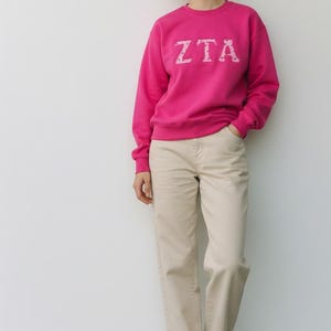 May include: A set of three ceramic mugs with a speckled, matte finish. The mugs are in shades of cream, light gray, and dark gray. Each mug has a simple, minimalist design and a rounded handle.