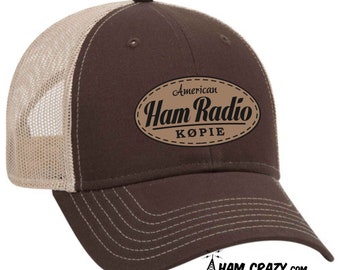 May include: Brown and tan trucker hat with a brown leather patch that says "American Ham Radio Kopie".