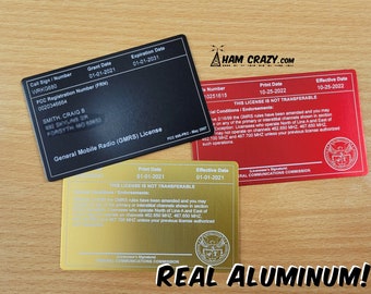 May include: Three metal license plates for a General Mobile Radio Service (GMRS) license. The plates are black, gold, and red. The black plate has the call sign WRKG680, the grant date 01-01-2021, and the expiration date 01-01-2031. The gold plate has the print date 01-01-2021 and the effective date 01-01-2021. The red plate has the license number 10251615, the print date 10-25-2022, and the effective date 10-25-2022. All three plates have the text "This license is not transferable" and the seal of the Federal Communications Commission.