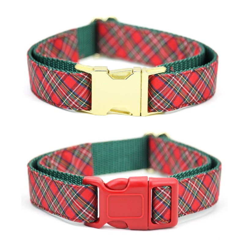 May include: Two pet collars featuring a red, green, and white plaid fabric pattern layered over a solid dark green nylon webbing strap. One collar has a shiny gold-toned metal side-release buckle, while the other has a solid red plastic buckle.