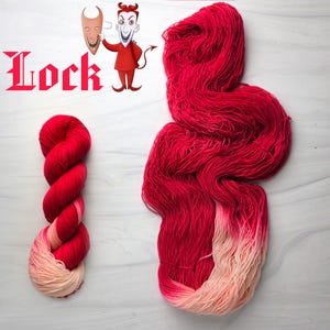 May include: Two skeins of red yarn, one twisted and the other loose, with a gradient to a light peach color. The word "Lock" is in red text. A cartoon devil character and a mask are in the upper left corner.