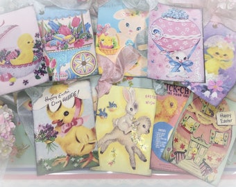 May include: A collection of vintage Easter cards featuring images of chicks, bunnies, and lambs. The cards are decorated with glitter and have a pastel color scheme.