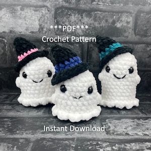 May include: Three crocheted ghost amigurumi wearing witch hats. The hats are black with blue, pink, and teal accents. The ghosts are white and have black eyes and mouths. The text "***PDF*** Crochet Pattern" and "Instant Download" is visible in the image.