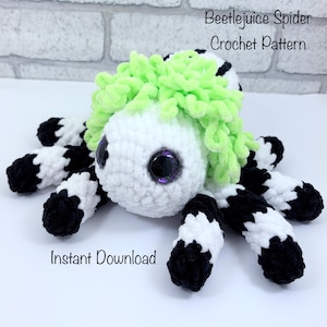May include: A crocheted spider toy with a white body, black and white striped legs, and green hair. The spider has large, purple-rimmed eyes. The image includes the text "Beetlejuice Spider Crochet Pattern" and "Instant Download."
