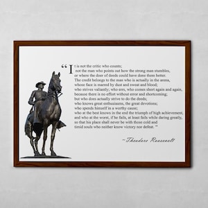May include: A framed print with a black and white quote by Theodore Roosevelt about the importance of action and perseverance. The quote is set against a background image of a bronze statue of a man on horseback.