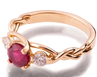 May include: A gold ring with a red ruby and two smaller diamonds. The ring has a braided band.