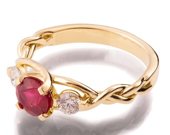 May include: A gold ring with a red ruby and two smaller diamonds. The ring has a braided band.