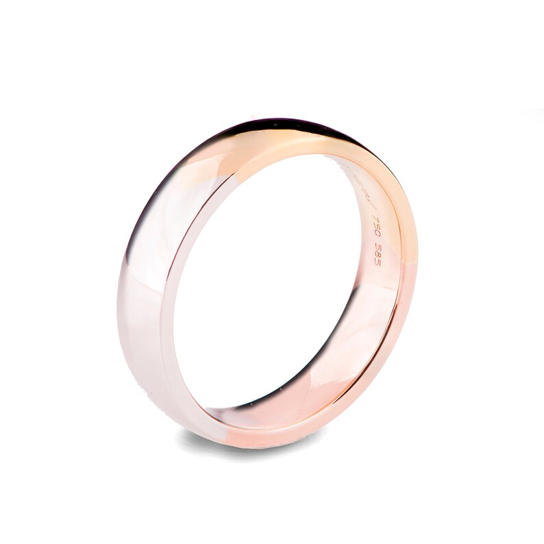 May include: A simple, polished, gold wedding band with a white gold band on one side and a rose gold band on the other side. The band is marked with "585 750".