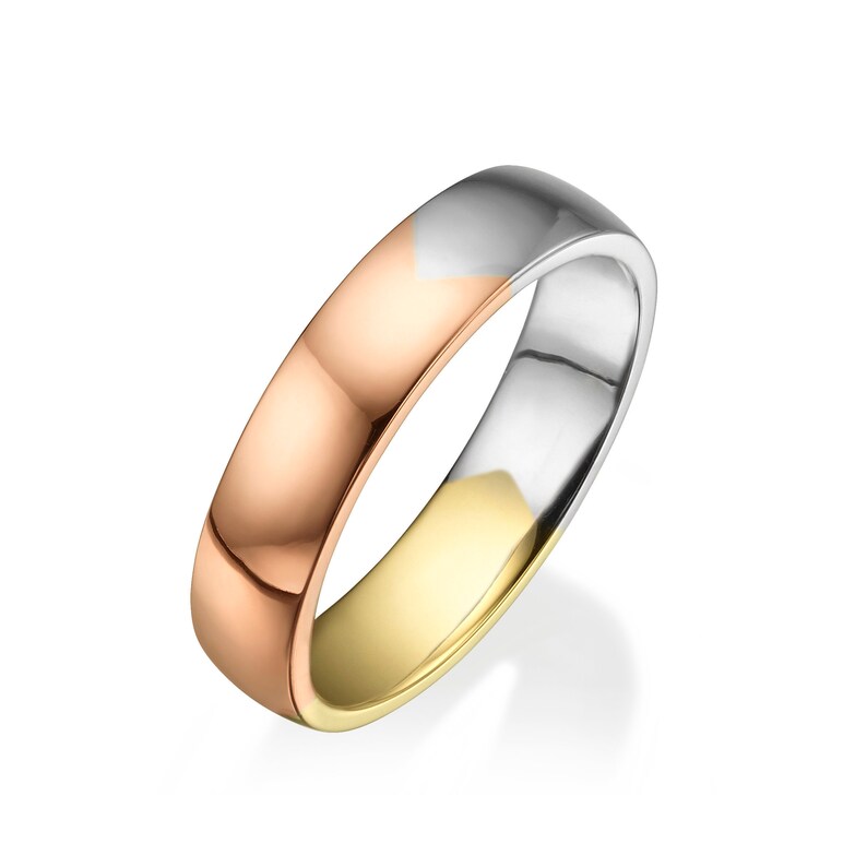 May include: A gold, silver, and rose gold wedding band. The band is made of three different metals, each with a different color.