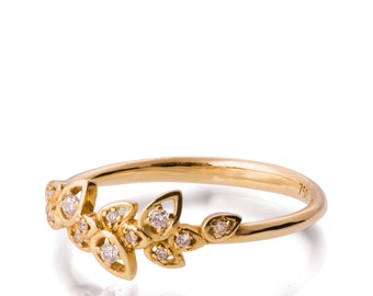 May include: A delicate gold ring featuring a design of leaves and small diamonds. The ring is crafted from 18 karat gold and is a beautiful and elegant piece of jewellery.