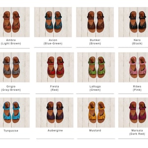May include: Twelve pairs of women's sandals in various colors, including brown, blue-green, black, gray-brown, red, green, pink, turquoise, aubergine, mustard, and dark red. The sandals have a buckle closure and a flat sole.
