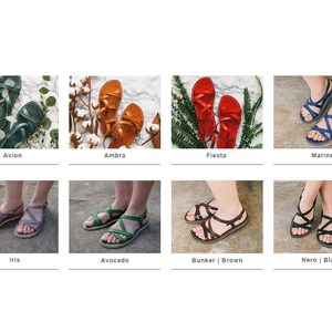 May include: A set of ten pairs of leather sandals in various colors, including blue, green, red, brown, and black. The sandals have a simple design with a single strap across the foot and a buckle closure.