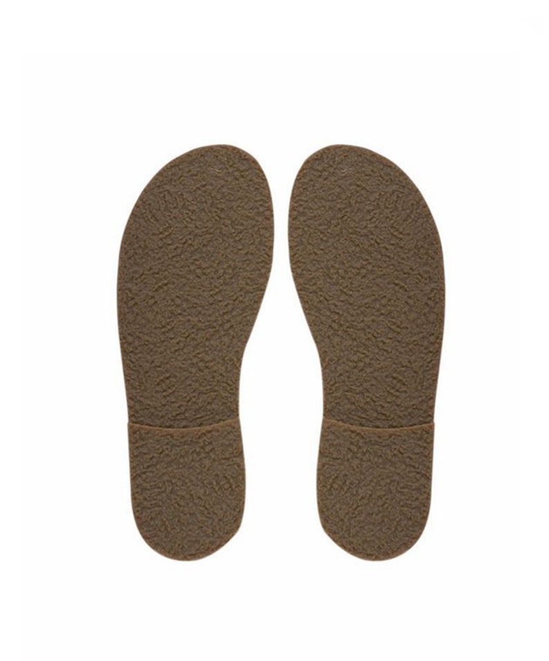 May include: A pair of brown leather soles with a textured surface.