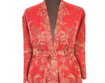 May include: A red robe with a floral and bird pattern. The robe has a tie belt and long sleeves.