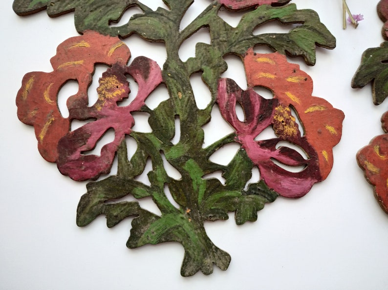 Peut inclure: Une d&eacute;coupe d'un motif floral avec des fleurs et des feuilles peintes en rouge, rose et vert.
