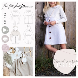 Peut inclure: Un patron de couture pour une robe à capuche pour fille avec un haut court. Le patron s'appelle "Crophhoodie Dress" et est de la marque "rosa rosa lieblingsschnitte". Le patron comprend des instructions pour réaliser la robe dans différents styles, notamment avec un devant boutonné, une bordure à volants et une capuche.