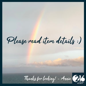 May include: A rainbow arches over a body of water with a cloudy sky. The text "Please read item details :)" is written in black cursive font. Below the rainbow, the text "Thanks for looking! - Anrie 216 vintage. Modern." is written in black cursive font.