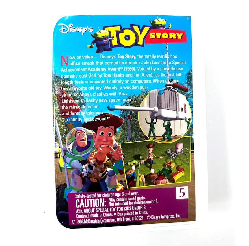 May include: A close-up of the back of a Toy Story trading card featuring Woody and Buzz Lightyear. The card is blue and green with the text "Disney's Toy Story" in white. The card also features a picture of Woody and Buzz Lightyear in a scene from the movie. The card is numbered 5.