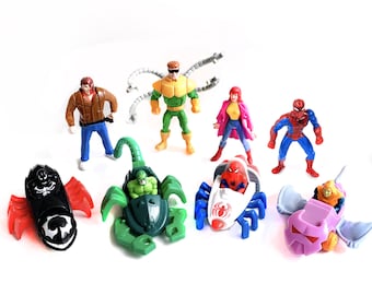May include: A collection of colorful Spider-Man action figures and vehicles. The figures include Spider-Man, Doctor Octopus, and others. The vehicles are in various shapes and colors, including a black and red jet and a purple glider.