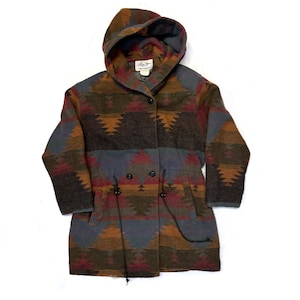 May include: A long-sleeved hooded jacket with a southwestern-style geometric pattern in shades of brown, red, blue, and green. The jacket has a drawstring waist and a button closure.