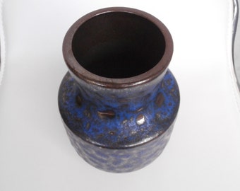 May include: A blue and brown ceramic vase with a textured surface.