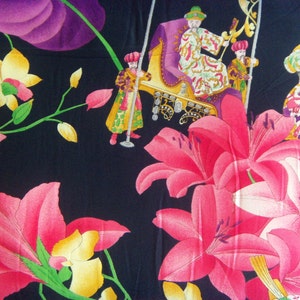 May include: Black fabric with a floral pattern featuring pink lilies, yellow orchids, and purple leaves. The fabric also features a scene of people in ornate clothing riding in a carriage.