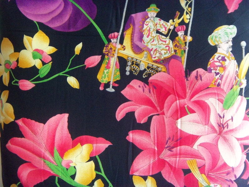 May include: Black fabric with a floral pattern featuring pink lilies, yellow orchids, and purple leaves. The fabric also features a scene of people in ornate clothing riding in a carriage.