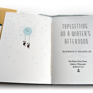 May include: A book titled "Typesetting on a Winter's Afternoon" by Raymond S. Nelson, Jr. The book cover features a blue clock with a pendulum and snowflakes on a white background.