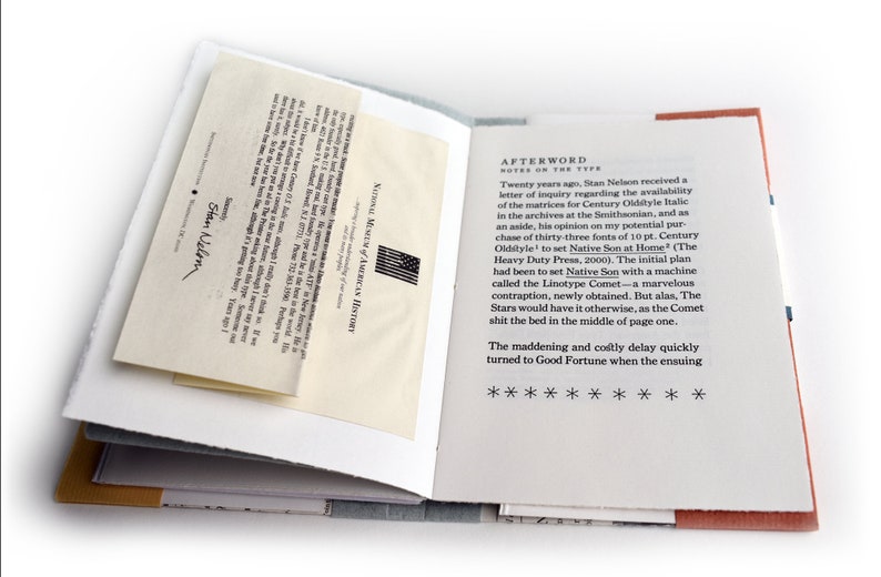 May include: A close-up of an open book with a white background and a red and orange border. The text on the page reads "AFTERWORD NOTES ON THE TYPE" and continues with a story about the process of setting type for a book. The book is titled "Native Son at Home".