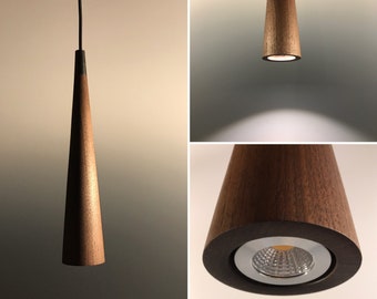 May include: A wooden pendant light with a conical shape and a warm white LED bulb. The light is suspended from a black wire.