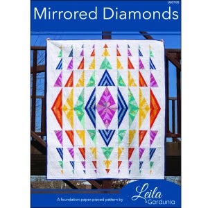 May include: A white quilt with a colorful geometric design featuring triangles and diamond shapes. The quilt has a blue border and is labeled "Mirrored Diamonds." The quilt is a foundation paper-pieced pattern by Leila Gardunia.