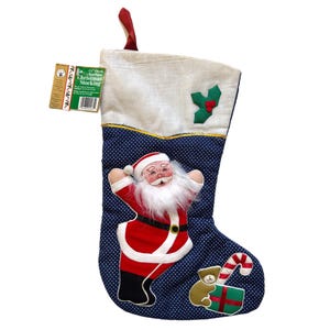 May include: A Christmas stocking with a blue polka dot pattern, featuring an applique of Santa Claus in a red suit. The stocking has a white top, a red loop, and a gold trim. A tag reads "15" Cloth Christmas Stocking".