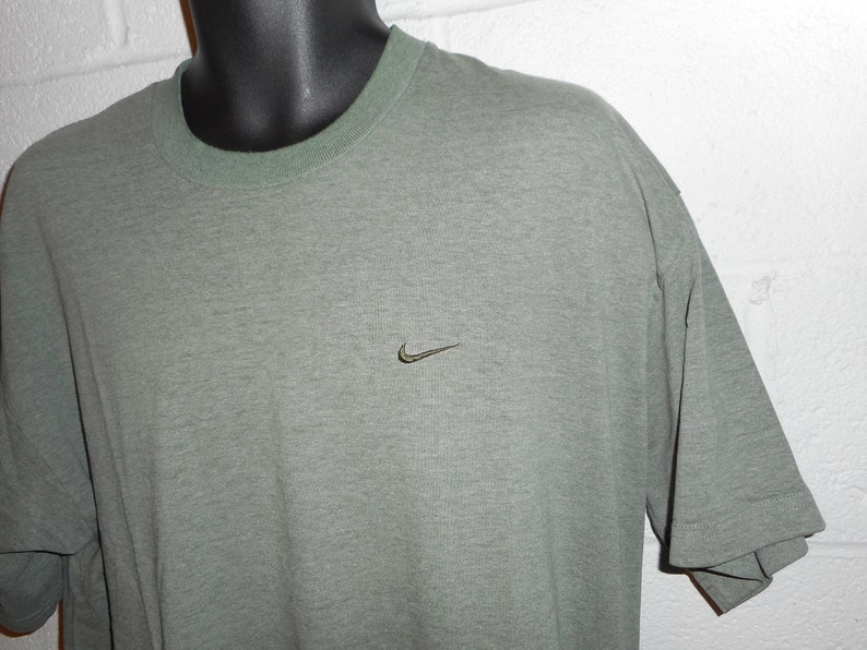 olive green and black nike shirt