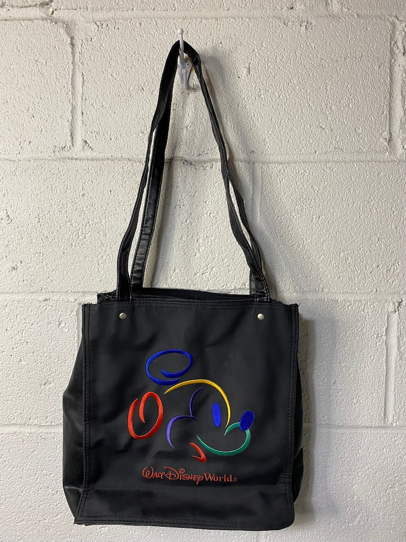 May include: Black tote bag with a colourful Mickey Mouse outline and the text "Walt Disney World."