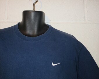 nike shirt with swoosh in middle