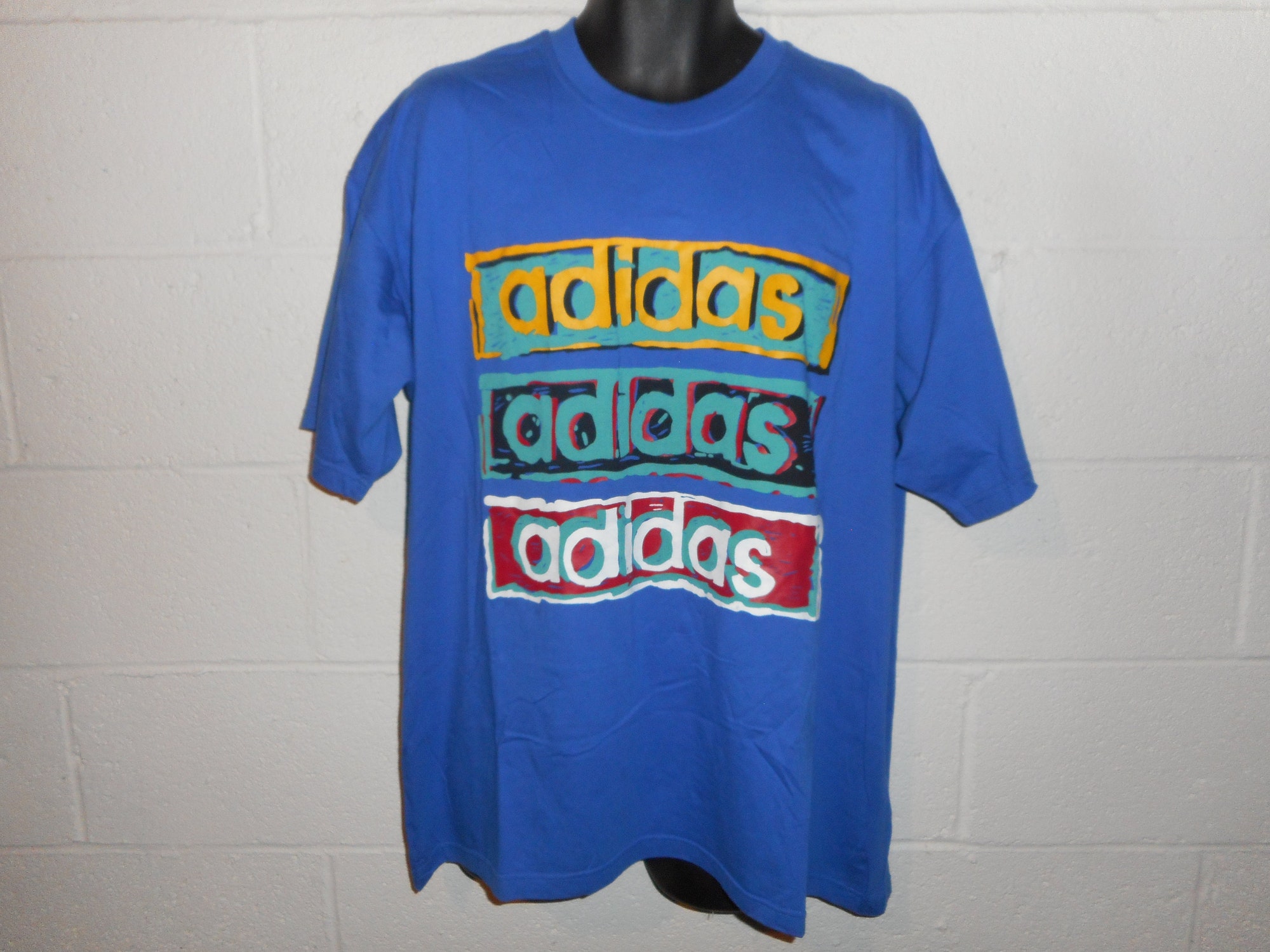Discover Vintage 90s Adidas Spell Out T-Shirt Fits