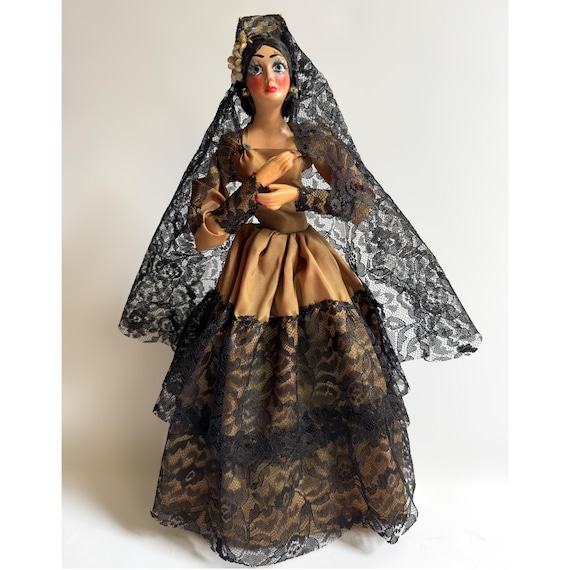 she's dressed in black in spanish Spanish, Beautiful, Brunette Flamenco Dancer with a Typical Flamenco Dress  in Black with White Polka Dots. she is Dancing in the Stock Image