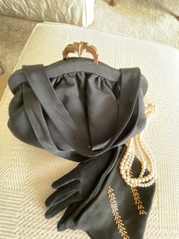 Black evening bag with kisslock closure