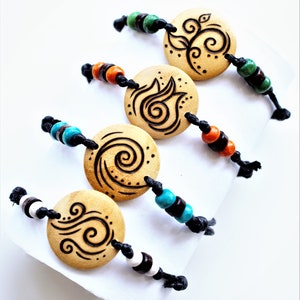 A stack of 4 bracelets with flat round wooden charms each showing one of the four elements.  Three small wooden beads adorn the cord at each side of the charm in various colours.