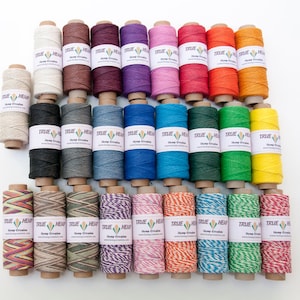 May include: Assortment of 30 spools of hemp twine in various colors, including natural, brown, red, purple, pink, orange, yellow, green, blue, black, and gray. Each spool has a label that reads "True Hemp" and "Hemp Creation".