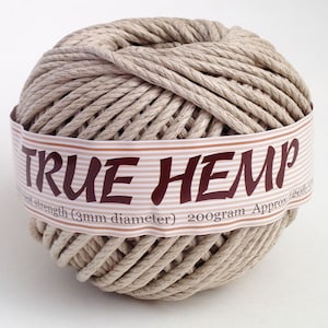 May include: A ball of natural-colored hemp cord with a label that reads "TRUE HEMP." The label also indicates the cord's diameter is 3mm and the weight is 200 grams. The cord is tightly wound.