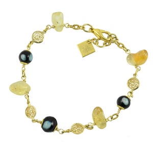 May include: Gold bracelet with a mix of gemstones and decorative features. It includes black and light blue beads, yellow-orange stones, and filigree accents. A small gold tag is attached near the clasp.